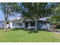 Charming single-story home with a well-maintained lawn, mature trees, and classic curb appeal at 6203 Candlewood Ln, Orlando, FL 32809