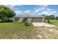 Charming single story home with a two car garage and neutral paint at 10453 Old Studio Rd, Clermont, FL 34711