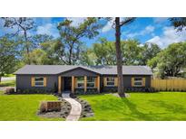 Beautifully renovated home with a landscaped front yard and inviting walkway to the front door at 1201 Manchester Rd, Maitland, FL 32751
