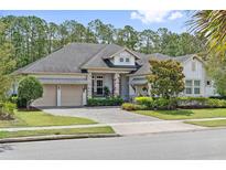 Charming home with a manicured lawn, beautiful landscaping, and a three-car garage at 13137 Lower Harden Ave, Orlando, FL 32827