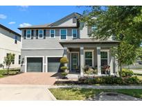 Charming two-story home with a brick driveway and well-manicured landscaping offers excellent curb appeal at 14639 Winter Stay Dr, Winter Garden, FL 34787