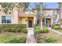 Charming townhome with a well-manicured front yard and inviting entrance at 14706 Driftwater Dr, Winter Garden, FL 34787