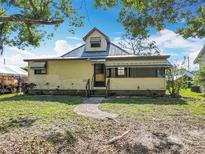 Charming one-story home featuring a welcoming front porch and a brick path leading to the entrance at 1511 New York Ave, St Cloud, FL 34769