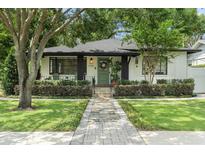 Charming single Gathering home featuring an inviting front porch, lush landscaping and brick pathway at 1701 Canton Street, Orlando, FL 32803