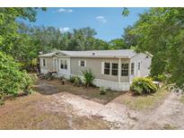 Charming single Gathering home with mature landscaping and a cozy sunroom, nestled in a peaceful, tree-lined neighborhood at 2229 N 6Th St, Orlando, FL 32820