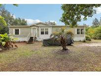 Charming single-story home with a well-maintained front yard and mature trees offering shade at 2229 N 6Th St, Orlando, FL 32820