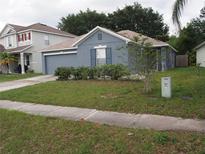 Charming single-story home featuring well-maintained landscaping and an attached two-car garage at 3055 Leflore Ln, Orlando, FL 32833