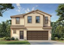 Inviting two-story home with neutral siding, a two-car garage, and charming landscaping at 3147 Cup Dr, Lakeland, FL 33803