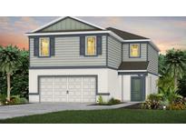 Two-story home with a two-car garage, gray siding, and tasteful landscaping at 3406 Haven Side Rd, Davenport, FL 33837