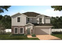 Two-story home with a stone veneer, two-car garage, green front lawn and beautifully landscaped front yard at 4062 Serene Water Ave, Eustis, FL 32736