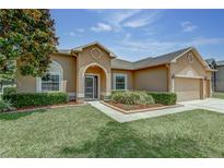 Charming home with well-manicured lawn, tidy landscaping, and neutral colored exterior at 420 Tulipwood Ln, Chuluota, FL 32766