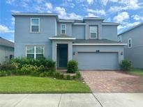 Charming two-story home with a brick driveway and beautiful, well-maintained landscaping at 5054 Tibet Ct, St Cloud, FL 34772