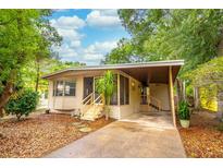 Inviting home with a screened porch, covered parking and lovely mature trees at 508 W Plantation Blvd, Lake Mary, FL 32746