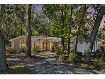 Charming single-story home surrounded by mature trees and lush landscaping at 626 Pearl Rd, Winter Springs, FL 32708