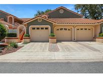 Charming townhouse featuring a terracotta tile roof and attached garages in a well-maintained community at 7858 Sugar View Ct # 7858, Orlando, FL 32819