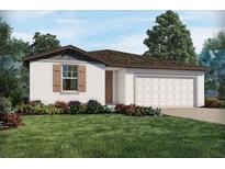 Charming single-story home featuring a well-manicured lawn and a two-car garage, creating a welcoming curb appeal at 1106 Cumberland Trail Dr, Lake Hamilton, FL 33851