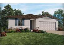 Inviting single-Gathering home featuring neutral paint, a well-kept lawn, and charming stone accents at 1122 Cumberland Trail Dr, Lake Hamilton, FL 33851