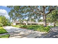 Charming single-story home with a well-maintained lawn, mature trees, and a long driveway at 1387 Sawgrass Court, Winter Park, FL 32792