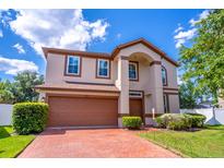 Charming two-story home featuring a brick driveway, two car garage and manicured landscaping at 1676 Song Sparrow Ct, Sanford, FL 32773