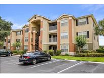 Attractive condo complex featuring a mix of stucco and siding, with well-maintained landscaping at 1979 Summer Club Dr # 115, Oviedo, FL 32765