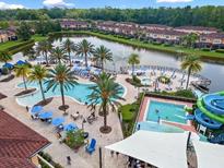 Resort-style community pools, waterslide, and lush landscaping create a tropical paradise at 2706 Camaro Dr, Kissimmee, FL 34746