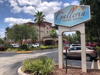 Exterior view of the Galleria Palms Hotel shows the main building and signage on a bright day at 3000 Maingate Ln # 210, Kissimmee, FL 34747