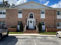 Charming brick two-story condo building featuring a welcoming front entrance and well-maintained landscaping at 4318 Lake Underhill Rd # 17A5, Orlando, FL 32803