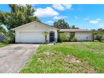 Charming single-story home with attached garage, landscaped lawn and inviting front entrance at 513 Dew Drop Cv, Casselberry, FL 32707