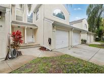 Inviting condo featuring a one-car garage and well-maintained landscaping, creating a welcoming curb appeal at 6057 Lake Pointe Dr # 408, Orlando, FL 32822
