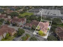 This is an aerial view of a multi-unit dwelling showcasing the building's layout and surrounding neighborhood at 12220 Wild Iris Way # 103, Orlando, FL 32837