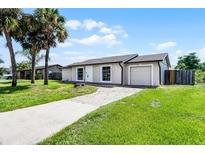 Charming single-story home with well-maintained lawn and updated exterior at 123 Tuxpan Ln, Kissimmee, FL 34743