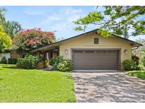 Charming single story home featuring an attached two car garage and a well manicured front lawn at 1247 Rosemary Dr, Orlando, FL 32807