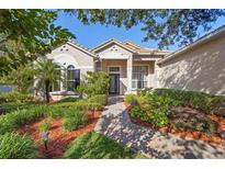 Charming home featuring manicured landscaping, tile roof, and a welcoming front entry at 215 Juniper Ridge Ct, Sanford, FL 32771