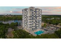 Stunning high-rise condo building with a pool and balconies overlooking the city and lake at 400 E Colonial Dr # 402, Orlando, FL 32803