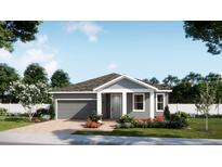 Charming single-story home featuring a grey exterior, an attached garage, and beautifully landscaped front yard at 4520 Laurel Site Loop, Apopka, FL 32712