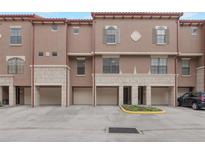 Attractive townhome featuring a tandem two-car garage and classic architectural elements at 6107 Metrowest Blvd # 104, Orlando, FL 32835