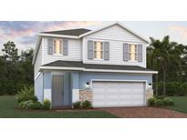 Charming two-story home featuring a two-car garage and a beautifully designed exterior at 7032 Rolling Leaf Rd, Groveland, FL 34736
