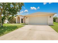 Charming single-story home with a well-manicured lawn and an attached two-car garage at 922 Hatteras Ave, Minneola, FL 34715