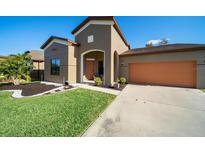 Charming one-story home with a well-manicured lawn and two-car garage in a Gathering-friendly neighborhood at 997 La Mirada Ct, Kissimmee, FL 34744