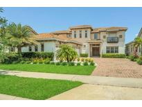 Stunning two-story home with a tile roof, well manicured lawn and mature landscaping at 13125 Alderley Dr, Orlando, FL 32832