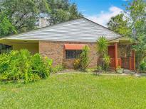 A charming home with brick and siding, complemented by lush landscaping and a welcoming entrance at 1591 Revere Ln, Daytona Beach, FL 32117