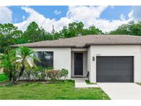 Charming single-story home with a well-manicured lawn, lush landscaping, and a convenient one-car garage at 20723 Macon Pkwy, Orlando, FL 32833