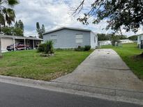 Charming single-story home with light blue siding and a well-maintained front yard at 2711 Cranmoor Dr, Kissimmee, FL 34758