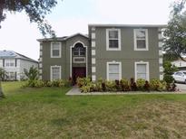 Charming two-story home with a well-maintained lawn and colorful landscaping at 2818 Sheila Dr, Apopka, FL 32712