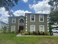 Charming two-story home features a well-manicured lawn and lush landscaping at 2818 Sheila Dr, Apopka, FL 32712