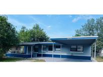 Charming single-story home featuring a covered carport and freshly painted in blue and grey at 2829 Sanford Ave, Sanford, FL 32773