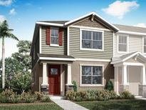 Charming two-story home with a well-manicured lawn and colorful landscaping at 3041 Douglas Fir Dr, Apopka, FL 32703