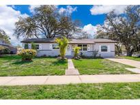 Charming single-story home featuring a landscaped front yard and a welcoming entrance at 3403 Canute Pl, Orlando, FL 32818