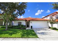Charming single-story home featuring a well-maintained lawn and a tile roof at 446 Summer Place Loop, Clermont, FL 34714