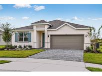 Charming one-story home with a brick driveway, a neutral-toned exterior, and a well-manicured lawn at 499 Silver Palm Dr, Haines City, FL 33844